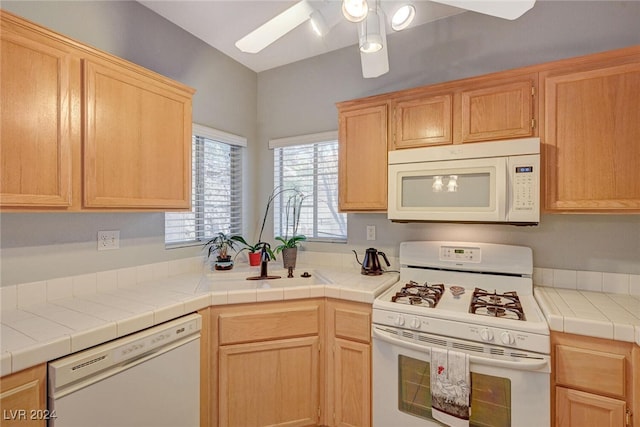 kitchen with tile countertops, white appliances, ceiling fan, and light brown cabinetry