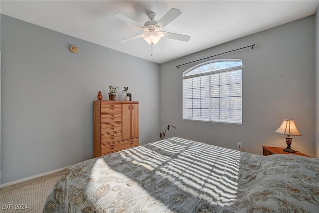 bedroom featuring a ceiling fan, carpet, and baseboards