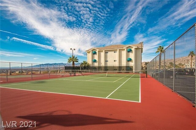 view of sport court with basketball hoop