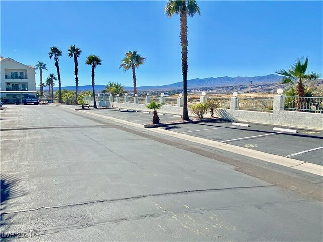 view of road with sidewalks, a mountain view, and curbs