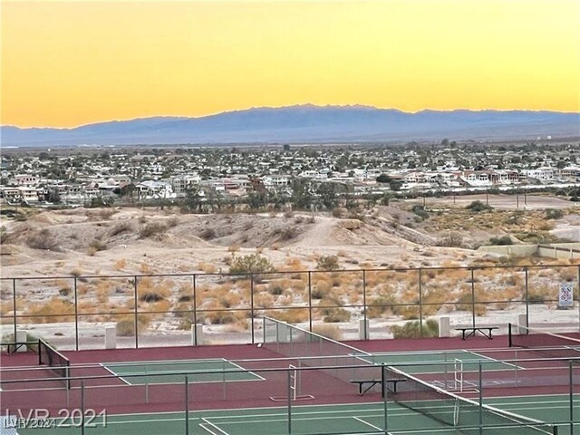 view of tennis court with a mountain view