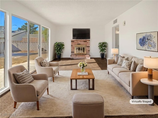 living room with a brick fireplace