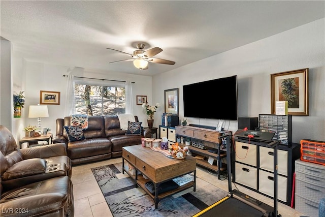 tiled living room featuring ceiling fan and a textured ceiling