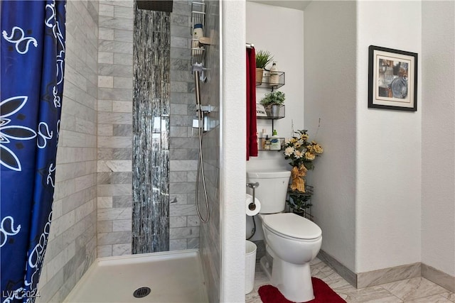 bathroom featuring toilet and walk in shower