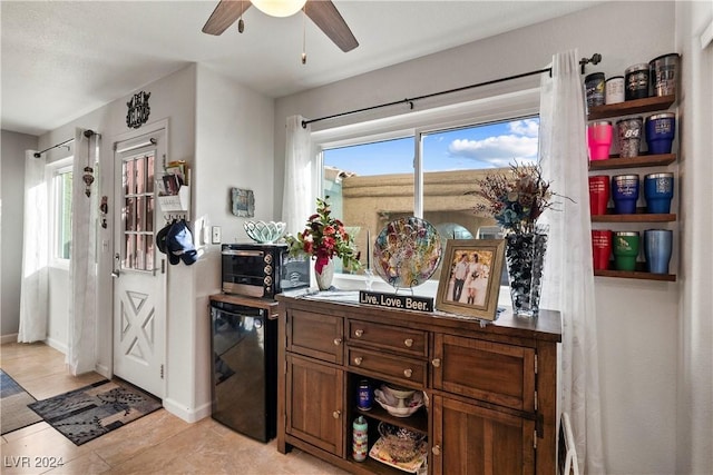 tiled office featuring ceiling fan