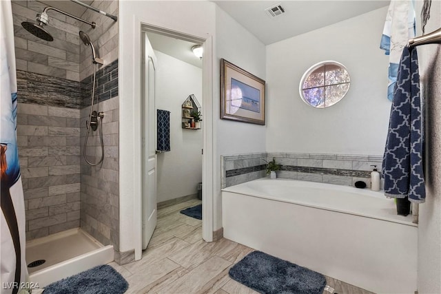 bathroom with separate shower and tub