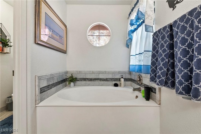 bathroom with a tub to relax in