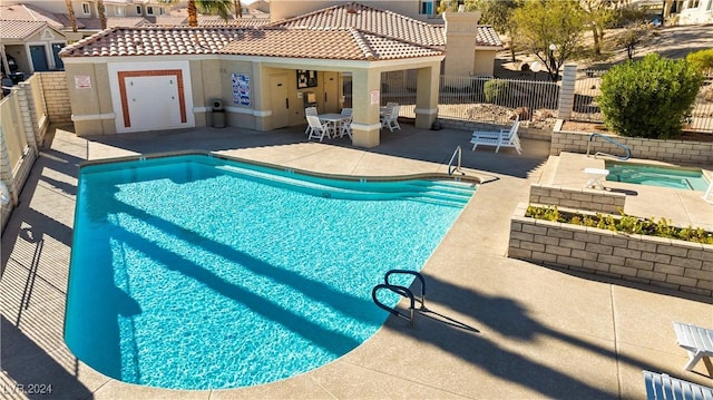 view of pool featuring a community hot tub and a patio area