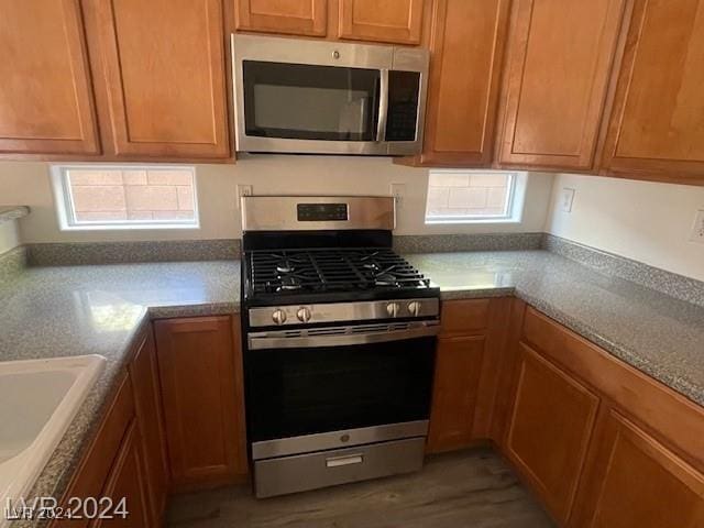 kitchen featuring sink, dark wood-type flooring, and appliances with stainless steel finishes