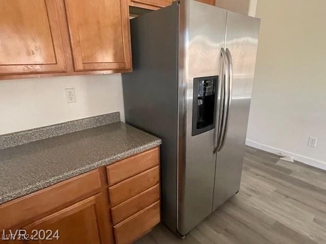 kitchen featuring hardwood / wood-style floors and stainless steel refrigerator with ice dispenser