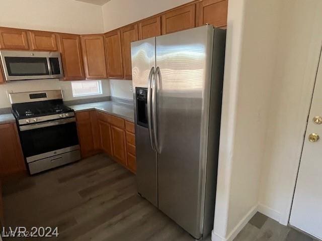 kitchen featuring dark hardwood / wood-style floors and stainless steel appliances