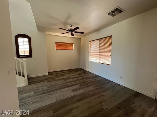 unfurnished room with dark hardwood / wood-style floors and ceiling fan