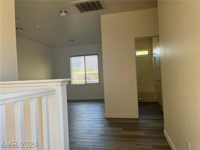 corridor with dark hardwood / wood-style floors