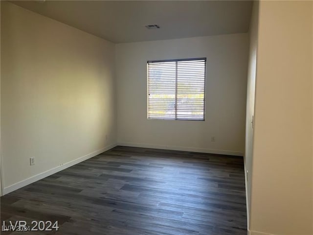 unfurnished room with dark hardwood / wood-style floors