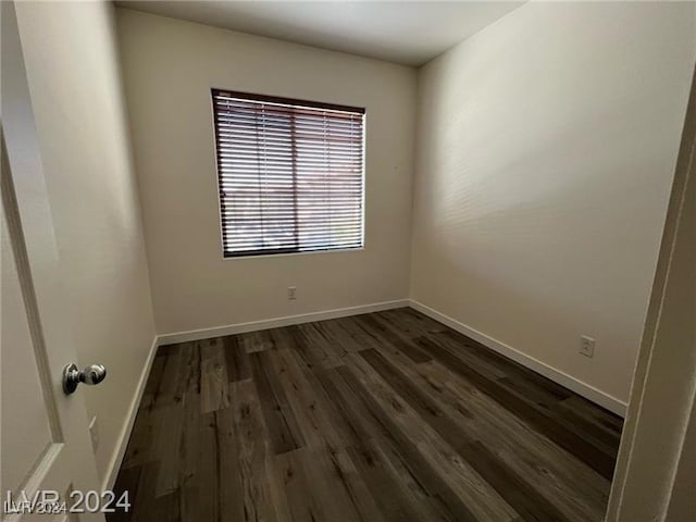 spare room with dark hardwood / wood-style floors