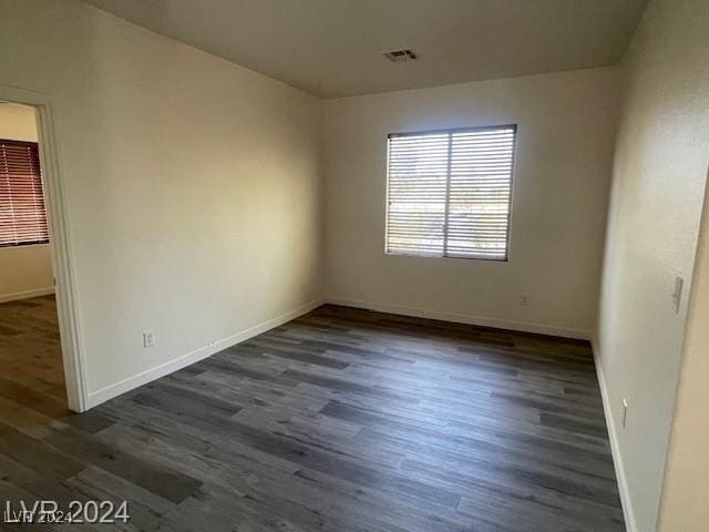 spare room featuring dark hardwood / wood-style flooring