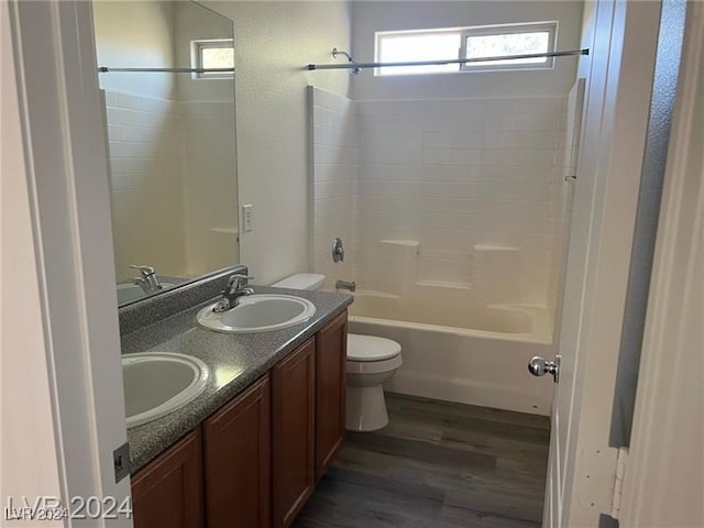 full bathroom with shower / bath combination, vanity, wood-type flooring, and toilet