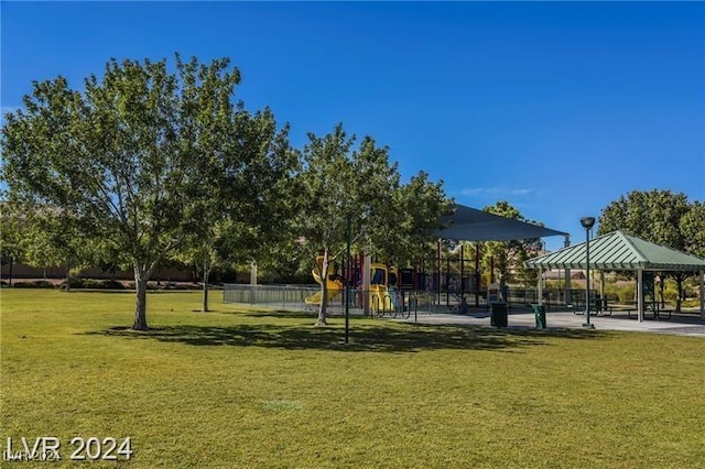 view of community featuring a gazebo, a playground, and a lawn