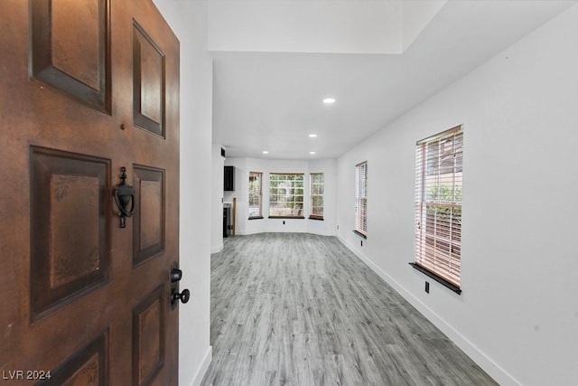 corridor with light hardwood / wood-style floors