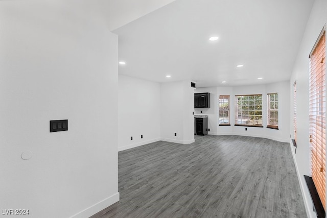 unfurnished living room featuring dark wood-type flooring