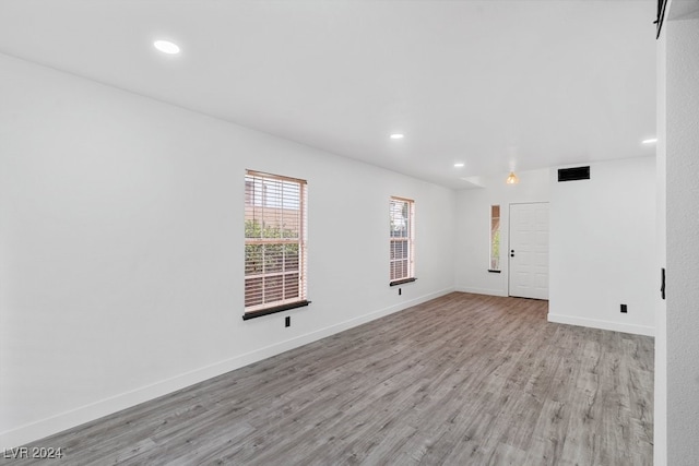 spare room featuring light hardwood / wood-style flooring