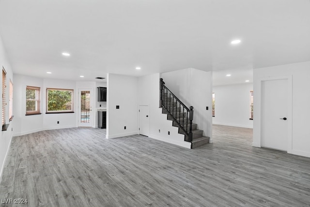 unfurnished living room with light wood-type flooring