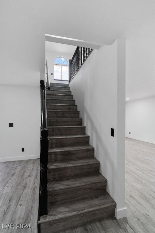 stairs with hardwood / wood-style floors