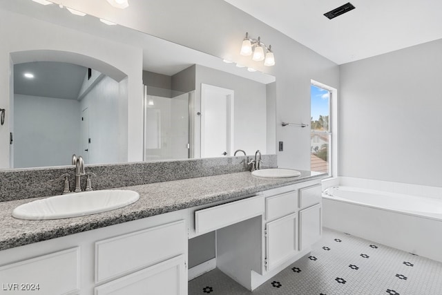 bathroom with tile patterned flooring, shower with separate bathtub, and vanity