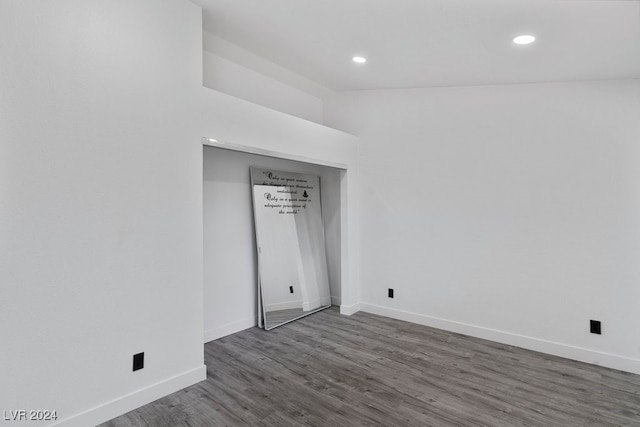 unfurnished bedroom with dark wood-type flooring