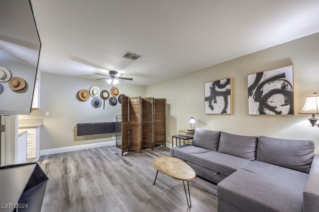 living room with ceiling fan and light hardwood / wood-style floors