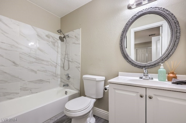 full bathroom featuring vanity, toilet, and tiled shower / bath combo