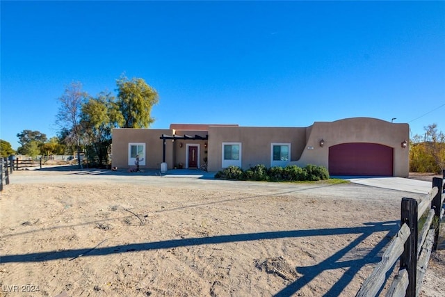 pueblo-style house featuring a garage