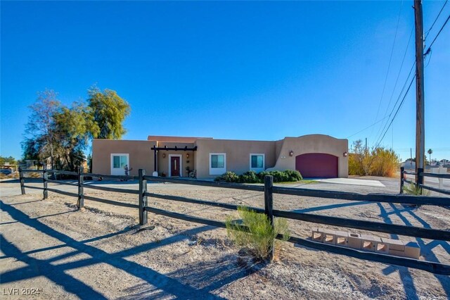 pueblo-style house with a garage