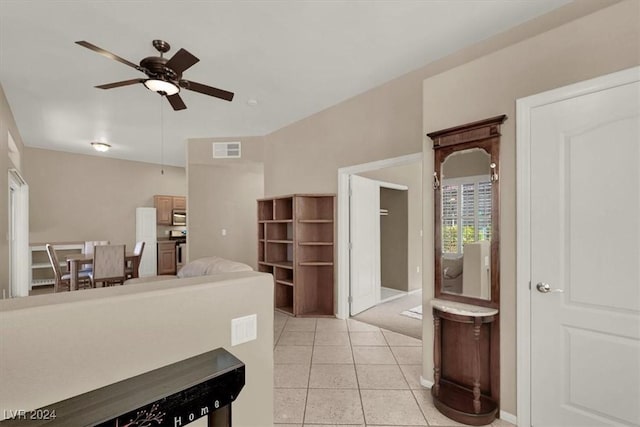 interior space featuring ceiling fan, light tile patterned floors, and stainless steel appliances