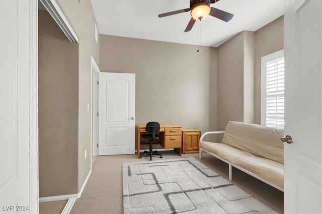 carpeted office space with ceiling fan