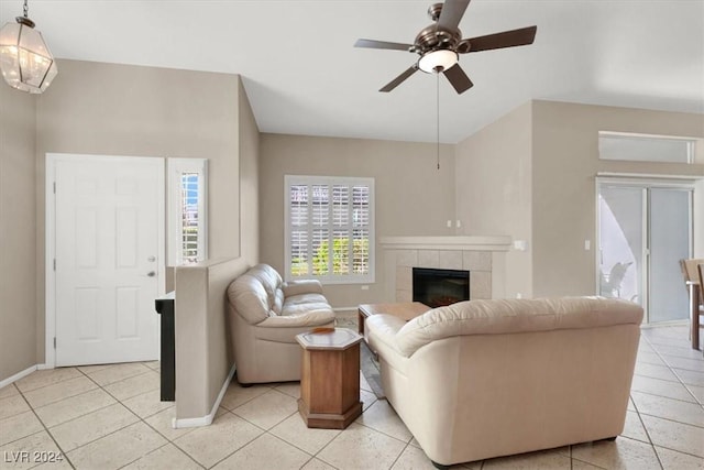 tiled living room featuring ceiling fan and a fireplace