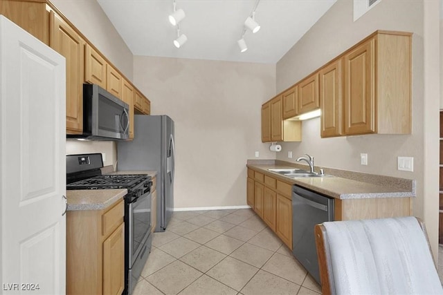 kitchen with appliances with stainless steel finishes, light brown cabinetry, track lighting, sink, and light tile patterned flooring