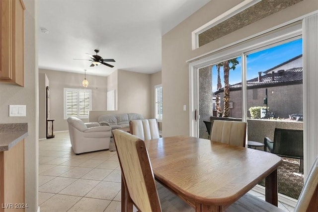 dining space featuring ceiling fan, light tile patterned floors, and a wealth of natural light