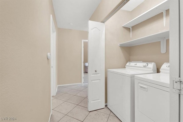 laundry room featuring light tile patterned floors and washer and dryer