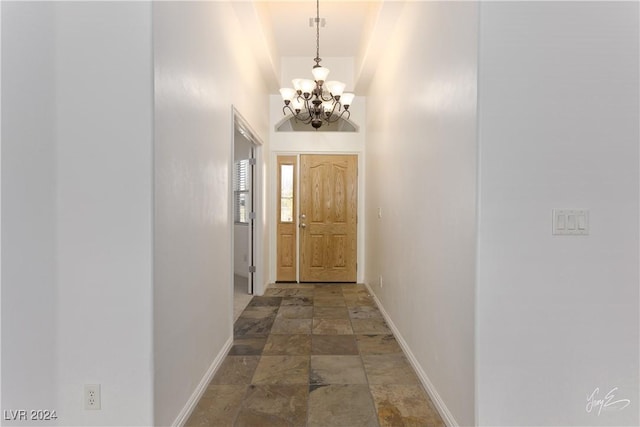 hallway featuring an inviting chandelier