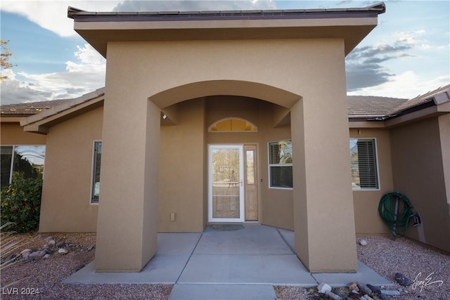 doorway to property featuring a patio