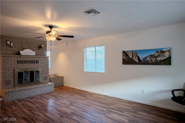 living room with ceiling fan, a fireplace, and hardwood / wood-style flooring