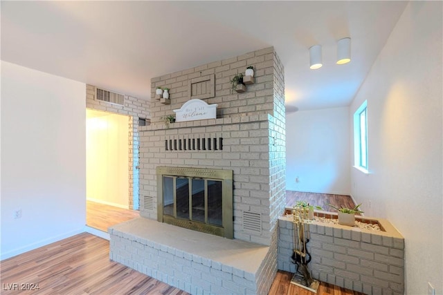 living room featuring hardwood / wood-style flooring and a fireplace