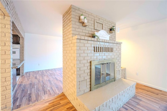 living room featuring a fireplace and hardwood / wood-style floors