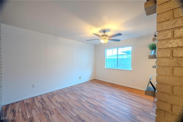 spare room featuring ceiling fan and wood-type flooring