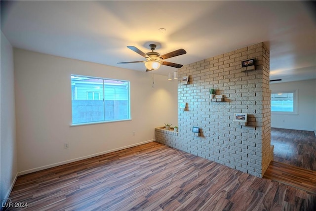 unfurnished room with wood-type flooring and ceiling fan