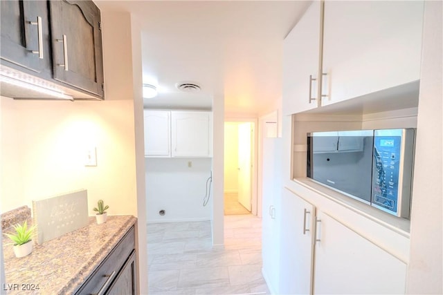 kitchen with dark brown cabinets and white cabinetry