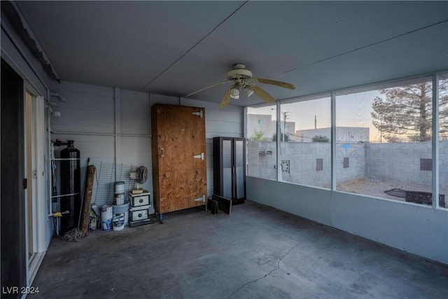 unfurnished sunroom with ceiling fan