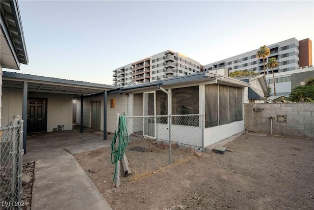 exterior space featuring a carport and a sunroom