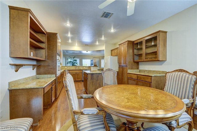 dining area featuring ceiling fan and light hardwood / wood-style floors